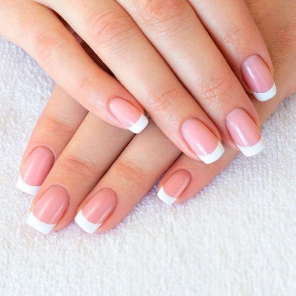 Glossy nude base with white tips close-up, business professional nail designs