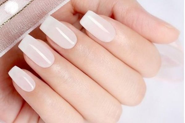 Clean white nails holding phone minimal style, professional looking nail designs