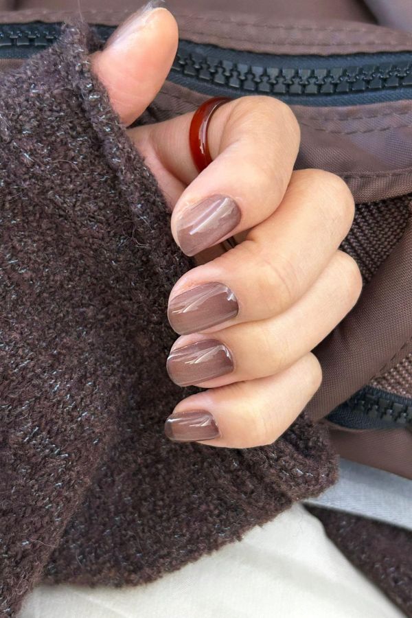 Taupe almond nails with fine gold line art glossy accents