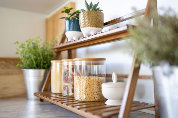 Glass jars catching sunlight, keeping the kitchen light and uncluttered