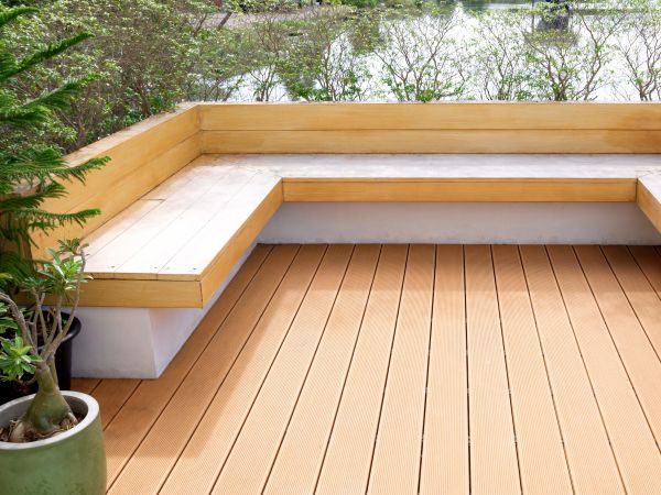 Tiny backyard deck corner with built-in bench