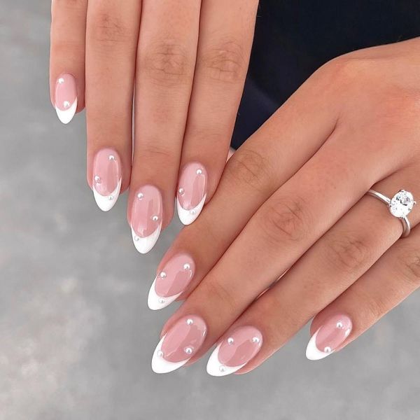 Elegant nail designs for weddings with pearl French tips on glossy milky pink almond nails - Tee Art Online