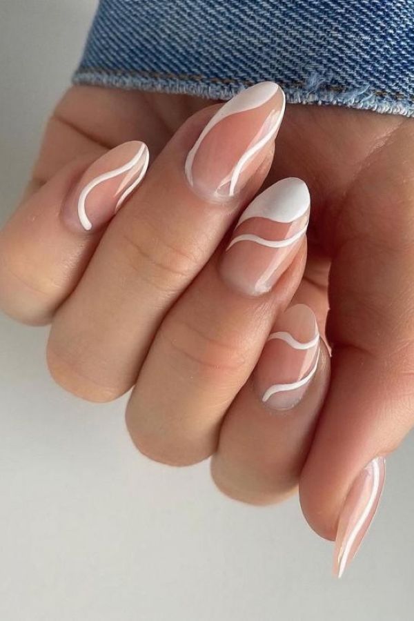 Ivory Satin Swirl Nails with glossy nude base and soft white wave details on almond nails