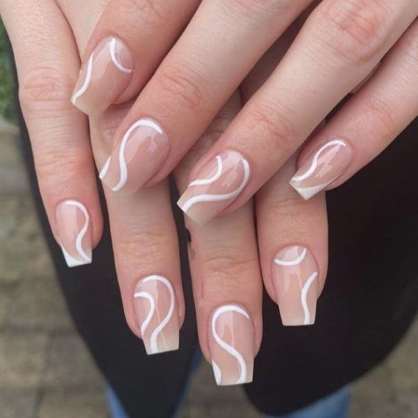Ivory Satin Swirl Nails with glossy nude polish and flowing white swirl details on square nails