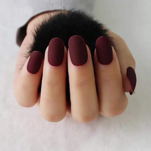 Elegant red nail designs for wedding celebrations with deep rose velvet matte nails on almond-shaped nails - Tee Art Online