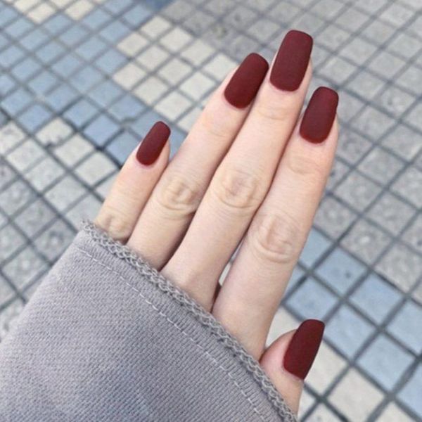 Elegant red nail designs for wedding events with matte burgundy coffin nails and a soft velvet finish - teeartonline.com