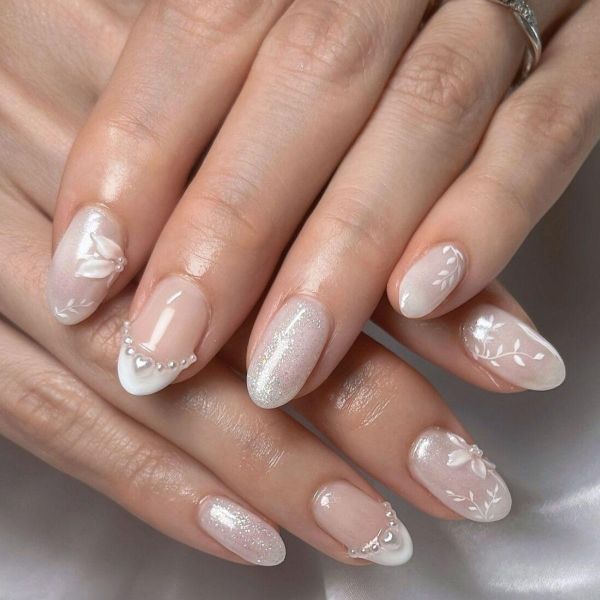 White Orchid Wedding Nails with soft nude polish, delicate floral nail art, and subtle pearl accents