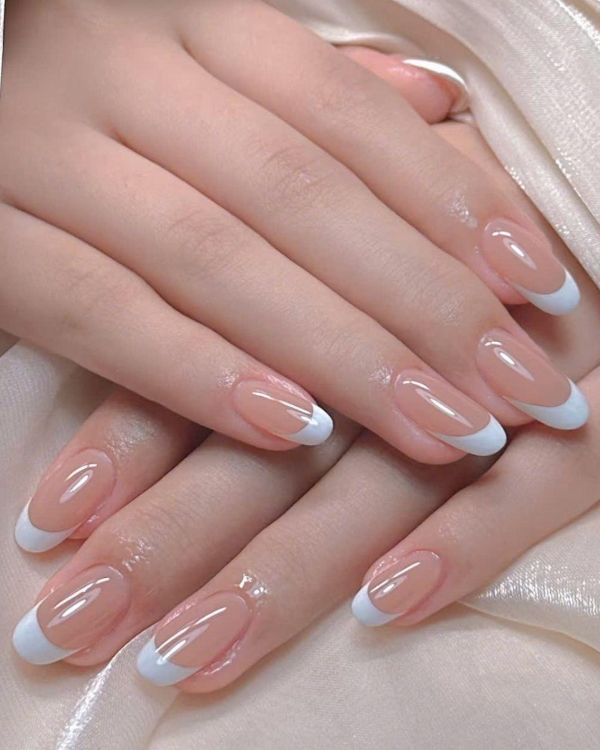 Elegant nail designs for a wedding with nude glass French tips and glossy almond nails