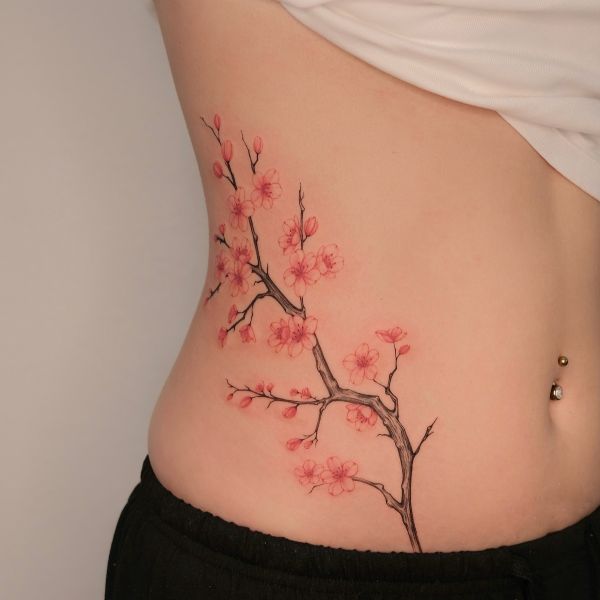 Cherry blossom flower tattoo waist with soft pink floral branches