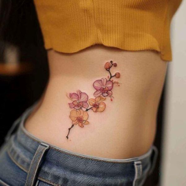 Pink orchid flower tattoo on waist with soft watercolor shading