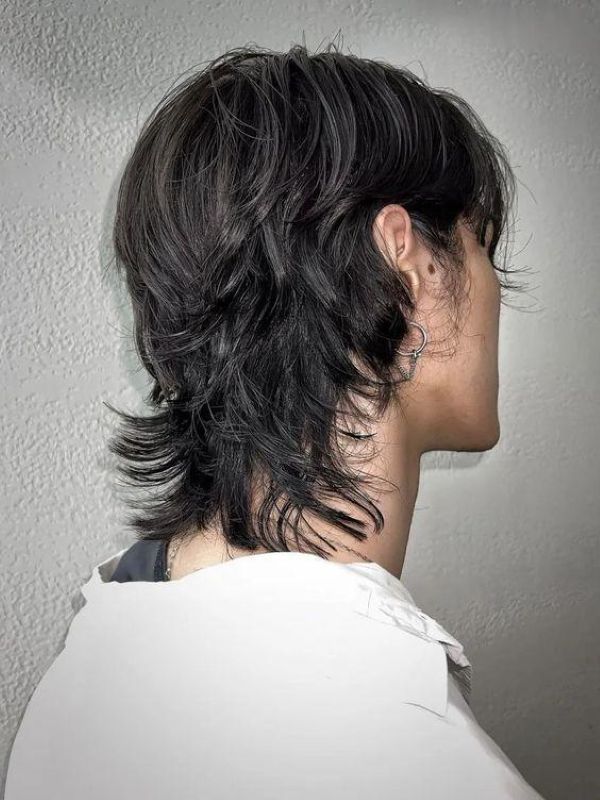 Modern wolf cut for men with straight hair medium length layered shag texture tapered ends