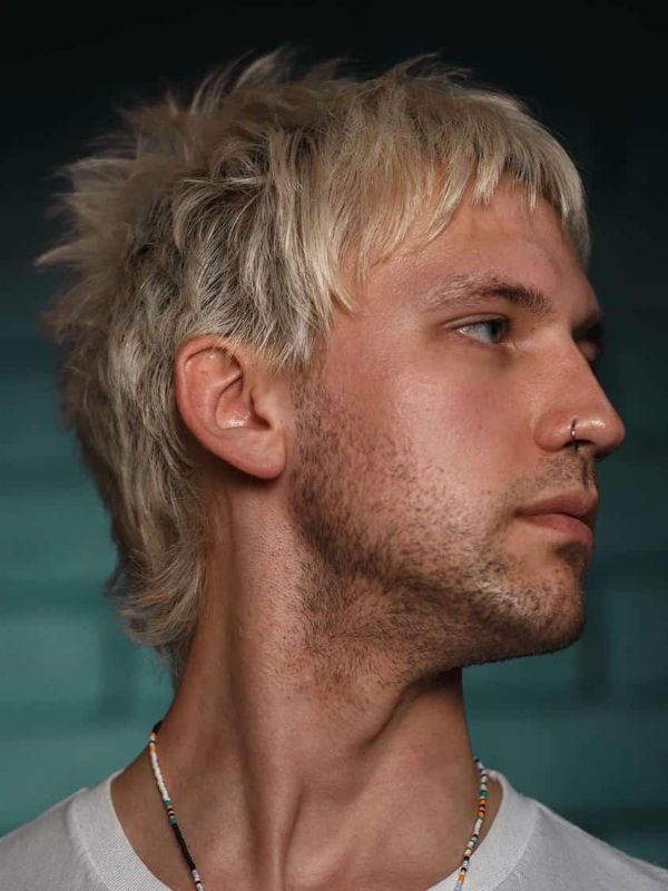 Airy textured shag men straight hair choppy layers medium length messy volume modern edgy