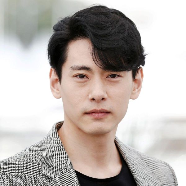 Side-swept directional flow haircut men straight hair medium length soft layers natural volume clean look