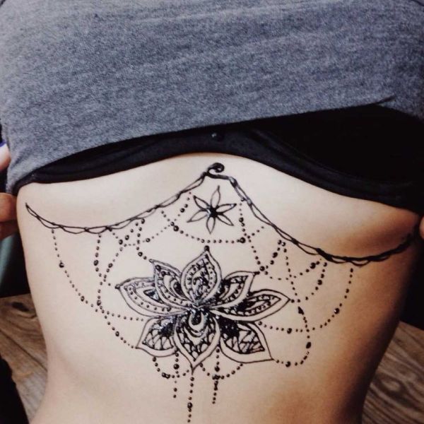 Floral spiderweb underboob tattoo with ornamental flower and dotted web details - Tee Art Online