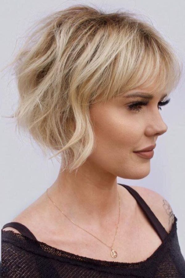 Short blonde bob with wispy waves and soft rounded volume