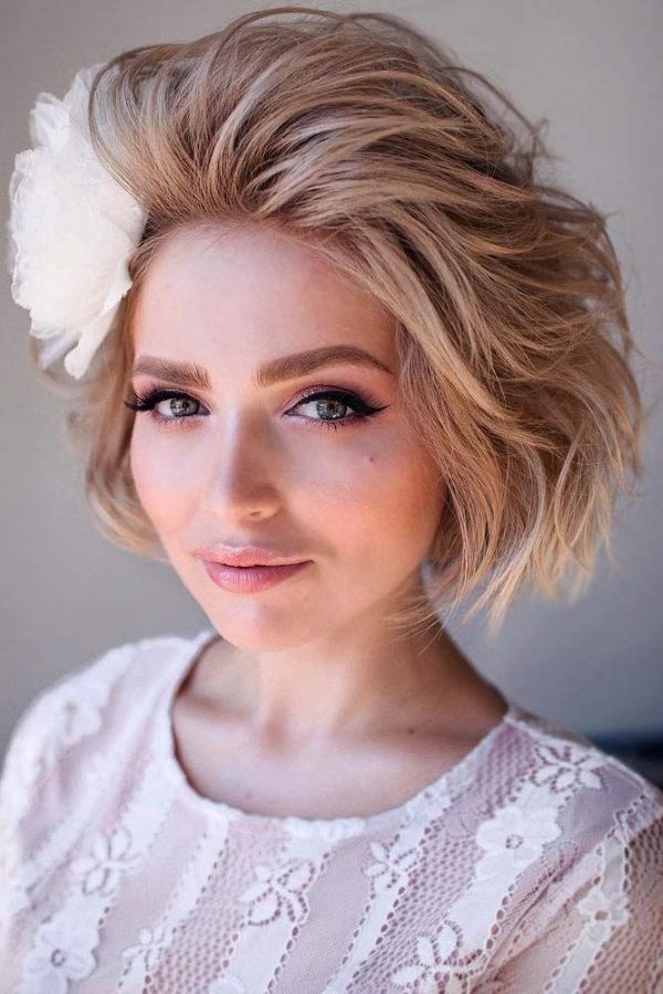 Short blonde bob with airy waves and soft voluminous texture
