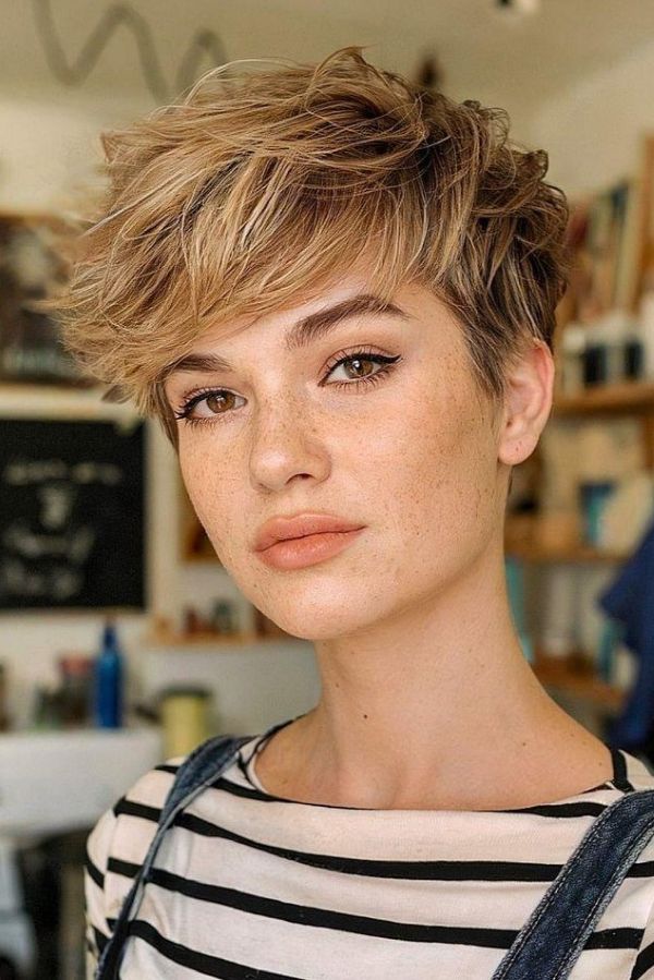 Textured blonde pixie with wispy layers and soft feathered volume