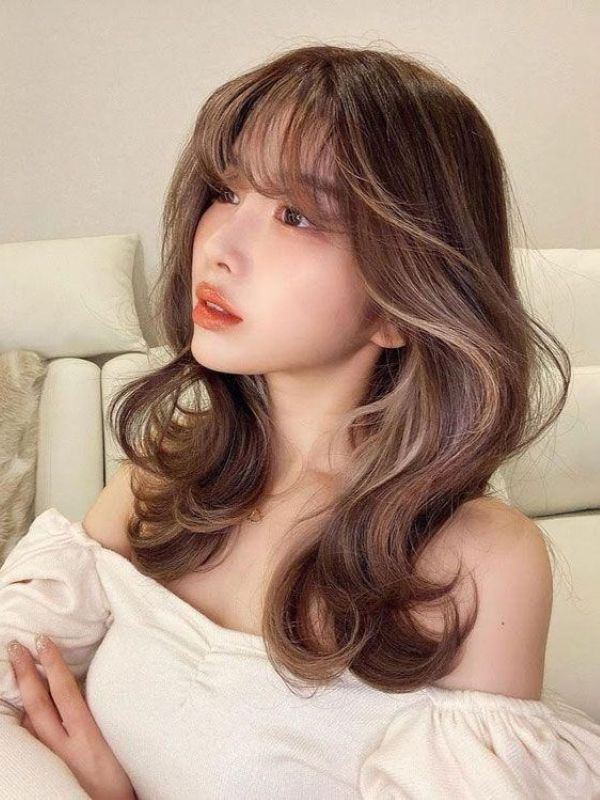 Easy Fairy Hairstyles with soft wispy bangs and voluminous layered curls